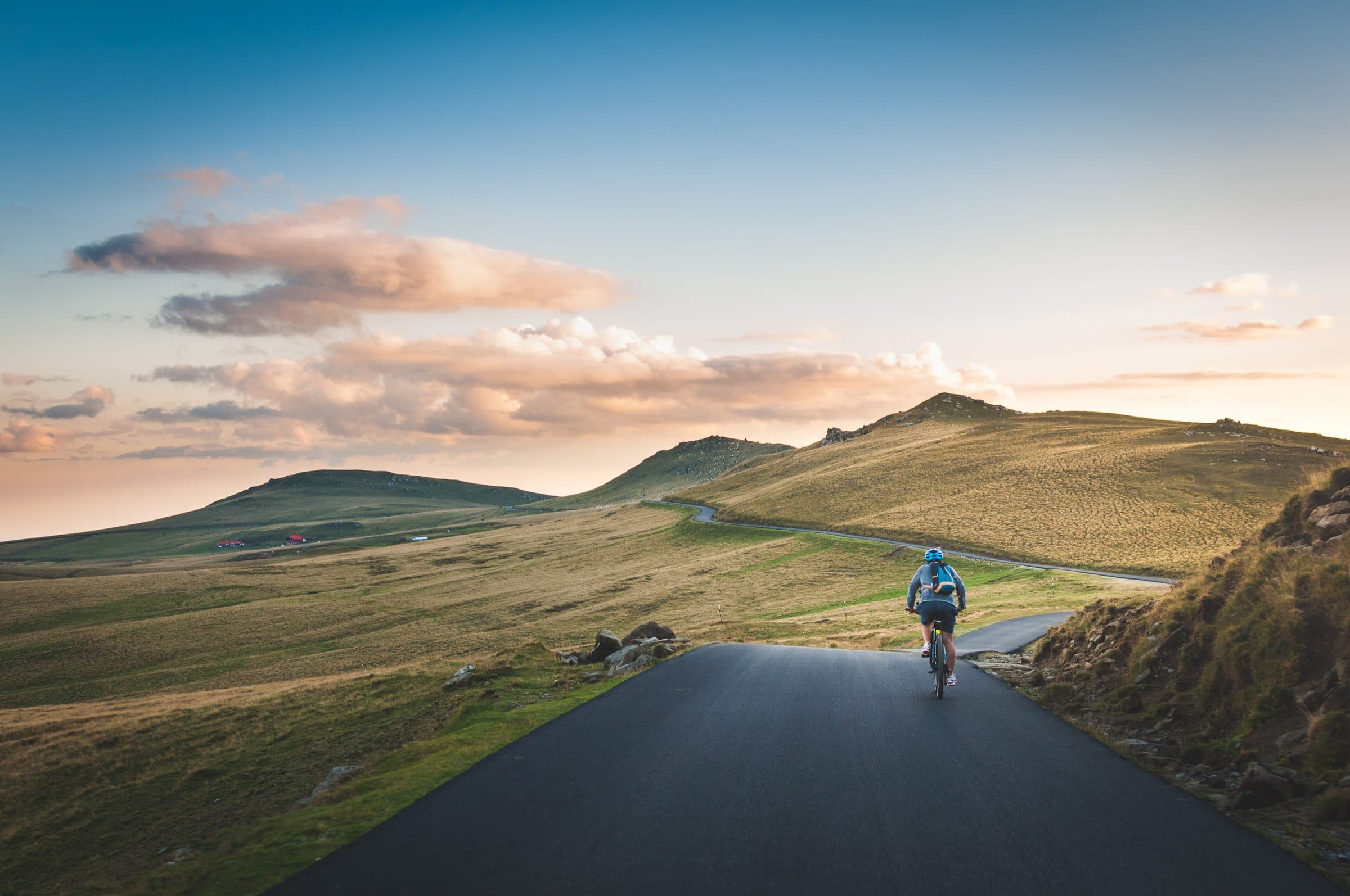 A cyclist climbing an empty mountain road
